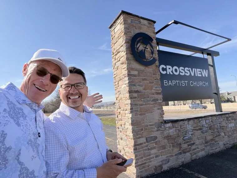ARCM Roofing’s Anthony Hong and Pastor Jeff Ayon at the Crossview Baptist Church sign in Denver