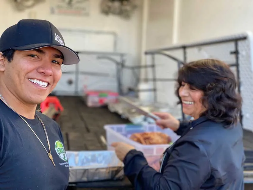 ARCM Cares volunteers serving Thanksgiving turkey from the ARCM food trailer